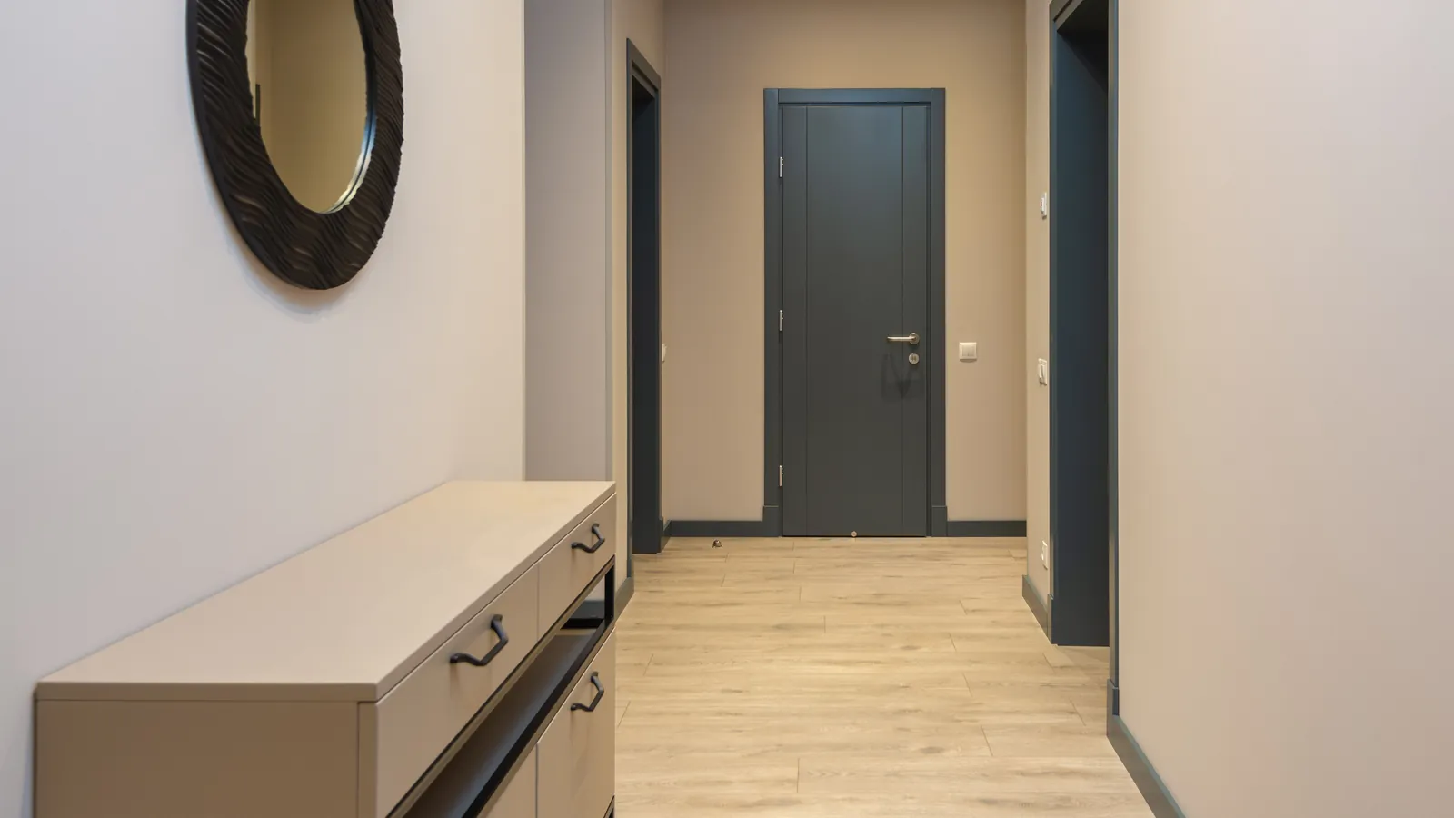Empty residential hallway with a light floor
