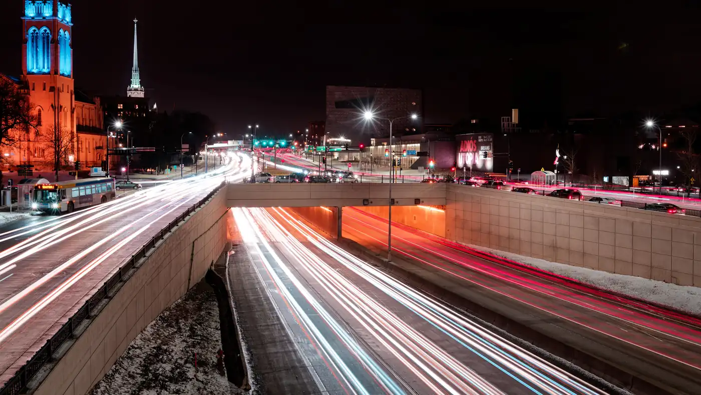 Long-exposure light trails on a city freeway at night